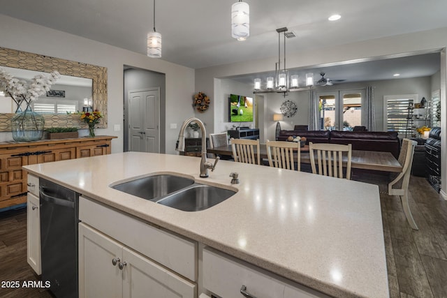 kitchen with dark wood-type flooring, open floor plan, a sink, and dishwasher