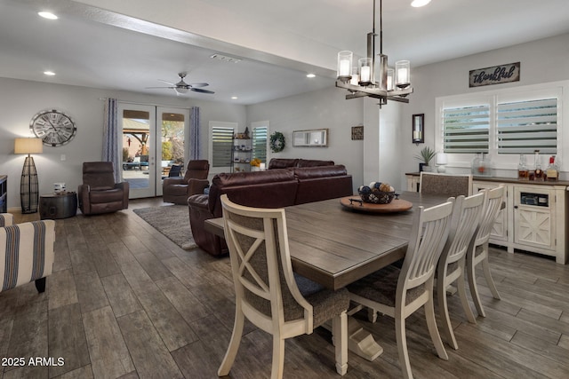 dining space featuring dark wood-style floors, visible vents, ceiling fan with notable chandelier, and recessed lighting