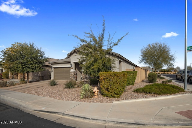 view of front of house featuring stucco siding, driveway, a garage, and a tiled roof