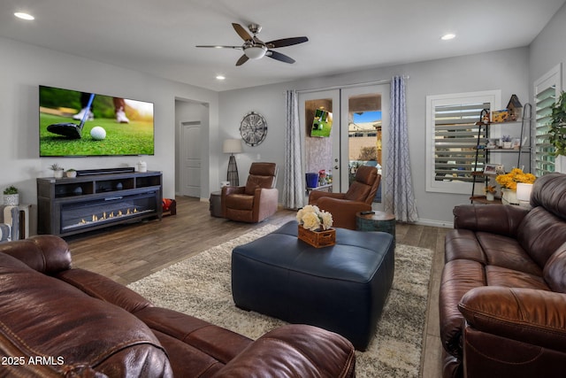 living room with a ceiling fan, recessed lighting, baseboards, and wood finished floors