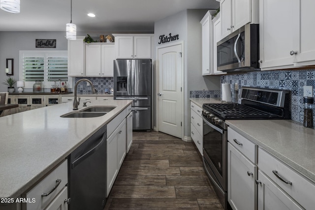 kitchen with light countertops, white cabinets, a sink, and stainless steel appliances