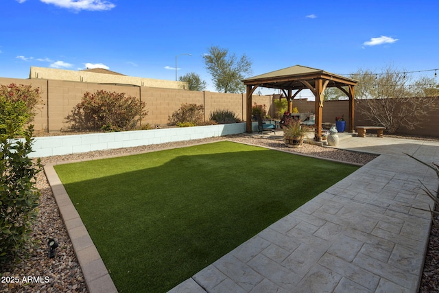 view of yard featuring a fenced backyard, a gazebo, and a patio area