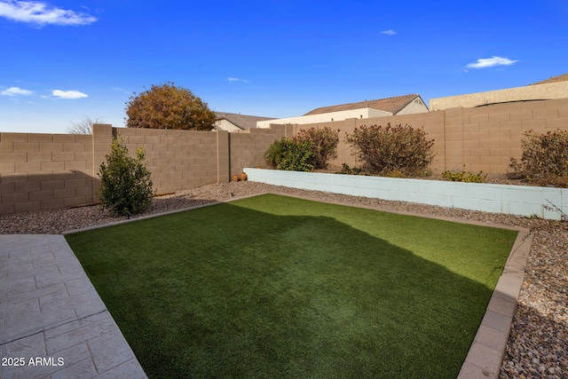 view of yard with a fenced backyard