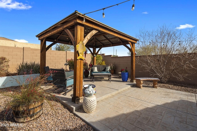 view of patio / terrace with a fenced backyard and a gazebo