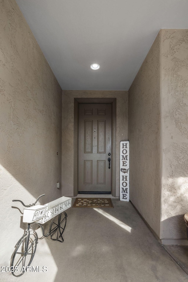 property entrance with stucco siding