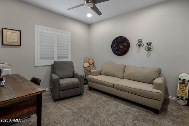 carpeted living area featuring baseboards and a ceiling fan