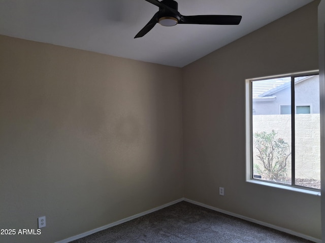 spare room featuring ceiling fan, plenty of natural light, vaulted ceiling, and carpet