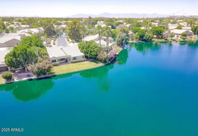 drone / aerial view featuring a water and mountain view