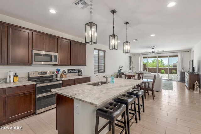 17973 W Ashley Dr, Goodyear, AZ 85338 - kitchen with stainless steel appliances, a sink, recessed lighting, ceiling fan, and open floor plan