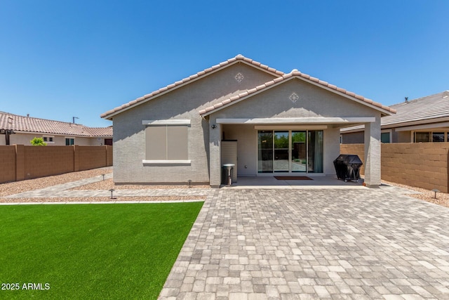 17973 W Ashley Dr, Goodyear, AZ 85338 - back of house featuring a patio area, stucco siding, and a tiled roof