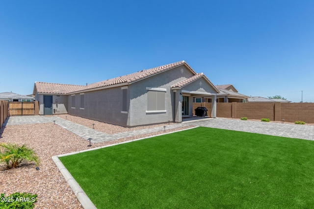17973 W Ashley Dr, Goodyear, AZ 85338 - rear view of house featuring a patio area, stucco siding, and a tiled roof