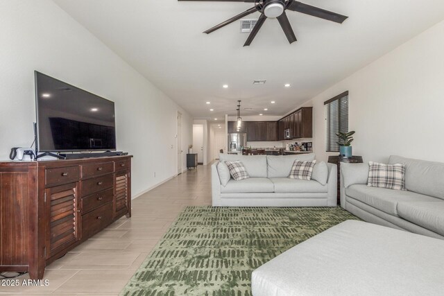 17973 W Ashley Dr, Goodyear, AZ 85338 - living area with a ceiling fan, recessed lighting, light wood finished floors, and baseboards