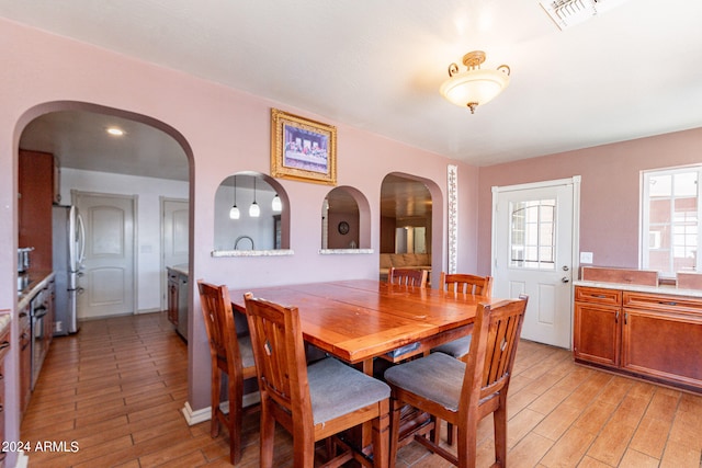 dining area featuring light wood-type flooring