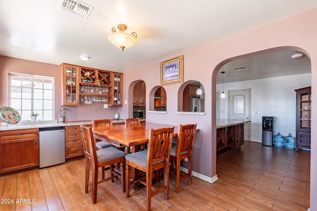 dining space with light hardwood / wood-style flooring