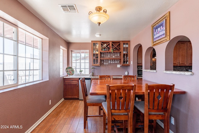 dining space with light hardwood / wood-style floors