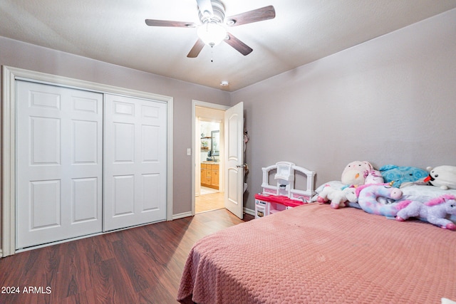 bedroom with a closet, ceiling fan, and dark hardwood / wood-style flooring