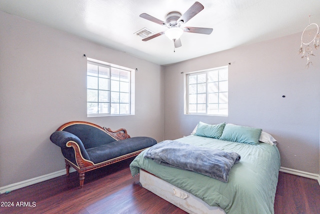 bedroom with dark hardwood / wood-style floors and ceiling fan