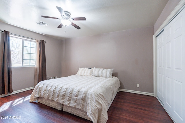 bedroom featuring a closet, dark wood-type flooring, and ceiling fan