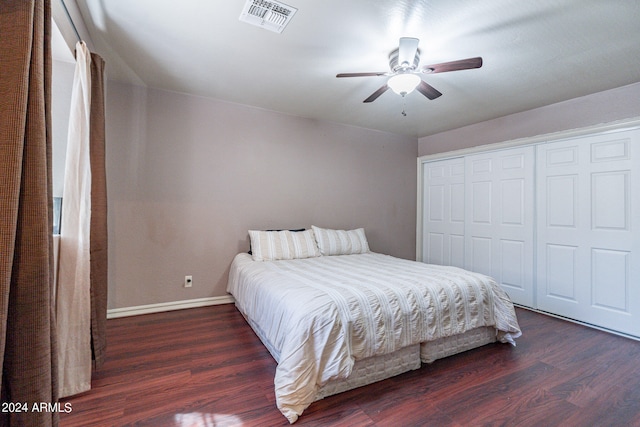 bedroom featuring a closet, dark wood-type flooring, and ceiling fan