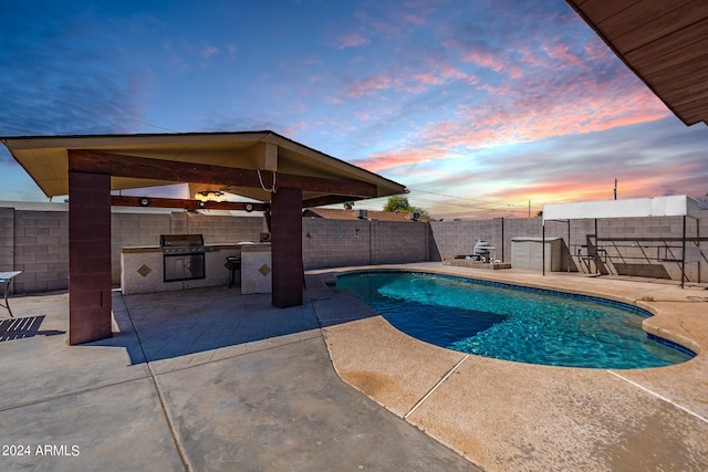 pool at dusk featuring a patio area