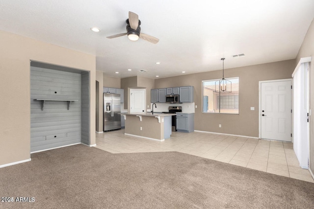 8795 W Windsor Dr, Peoria, AZ 85381 - unfurnished living room with light colored carpet, a sink, baseboards, ceiling fan, and recessed lighting