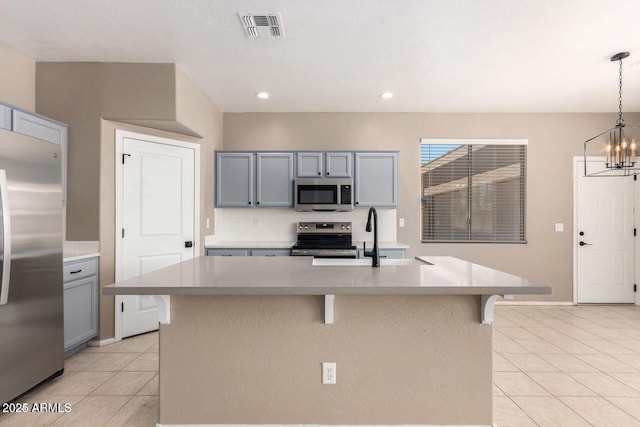 8795 W Windsor Dr, Peoria, AZ 85381 - kitchen featuring stainless steel appliances, light tile patterned floors, light countertops, gray cabinets, and backsplash
