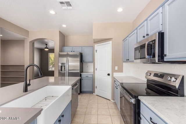 8795 W Windsor Dr, Peoria, AZ 85381 - kitchen featuring appliances with stainless steel finishes, tasteful backsplash, light countertops, recessed lighting, and light tile patterned flooring
