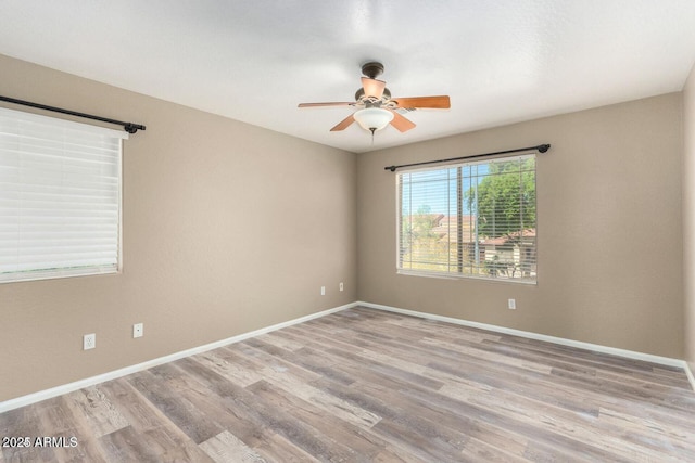 8795 W Windsor Dr, Peoria, AZ 85381 - unfurnished room featuring ceiling fan, wood finished floors, and baseboards
