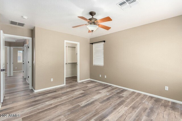 8795 W Windsor Dr, Peoria, AZ 85381 - unfurnished bedroom featuring baseboards, light wood finished floors, and a closet