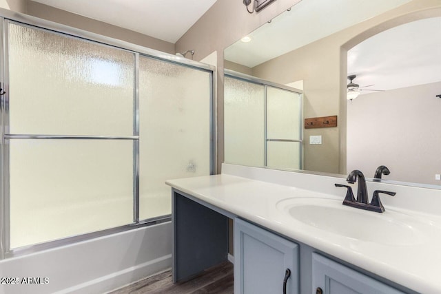8795 W Windsor Dr, Peoria, AZ 85381 - bathroom with ceiling fan, vanity, wood finished floors, and bath / shower combo with glass door