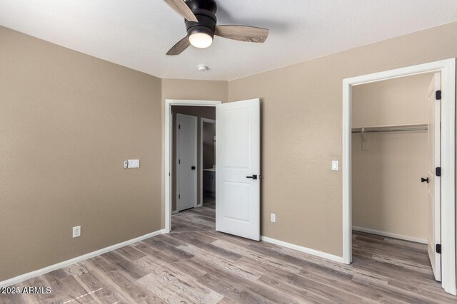8795 W Windsor Dr, Peoria, AZ 85381 - unfurnished bedroom with wood finished floors, a closet, and baseboards