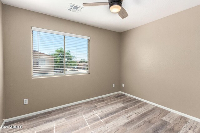 8795 W Windsor Dr, Peoria, AZ 85381 - unfurnished room with ceiling fan, wood finished floors, and baseboards