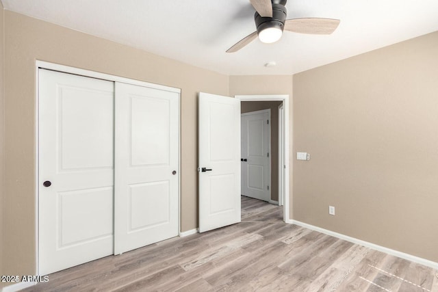 8795 W Windsor Dr, Peoria, AZ 85381 - unfurnished bedroom featuring light wood-style floors, baseboards, a closet, and a ceiling fan