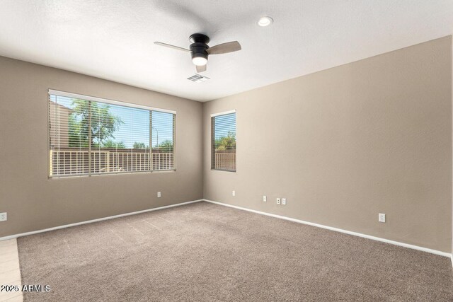 8795 W Windsor Dr, Peoria, AZ 85381 - carpeted spare room featuring healthy amount of natural light, ceiling fan, and baseboards