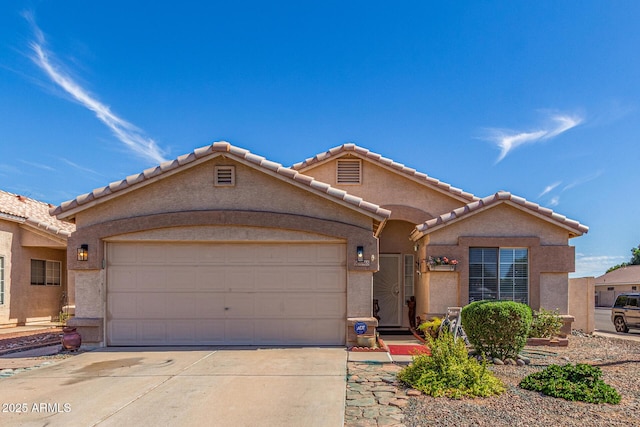 10465 W Windsor Blvd, Glendale, AZ 85307 - mediterranean / spanish-style home featuring driveway, an attached garage, stucco siding, and a tiled roof