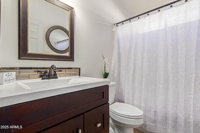 10465 W Windsor Blvd, Glendale, AZ 85307 - bathroom with toilet, vanity, and a textured wall