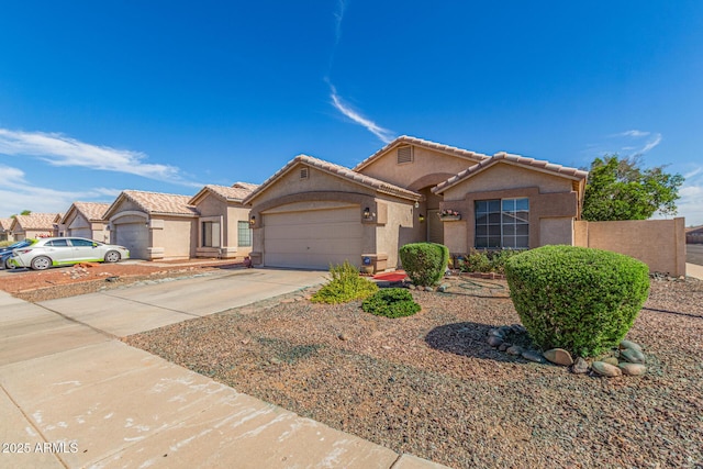10465 W Windsor Blvd, Glendale, AZ 85307 - view of front of house with stucco siding, concrete driveway, a garage, and a tile roof