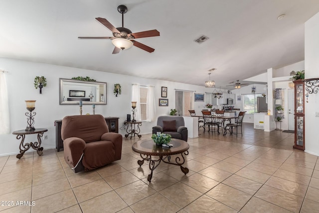 10465 W Windsor Blvd, Glendale, AZ 85307 - living room featuring ceiling fan, vaulted ceiling, light tile patterned flooring, and baseboards