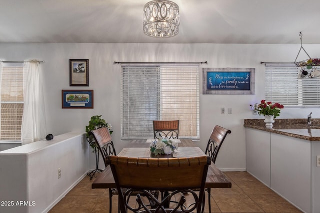 10465 W Windsor Blvd, Glendale, AZ 85307 - dining space with tile patterned floors, a chandelier, and baseboards