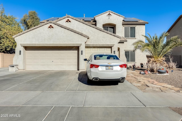 view of front facade featuring a garage and solar panels