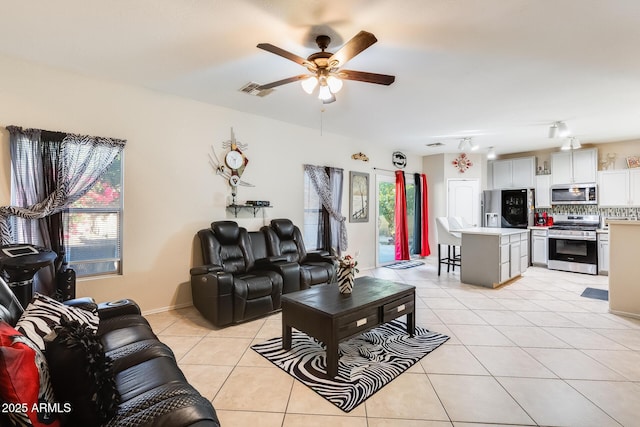 living room featuring light tile patterned floors and ceiling fan