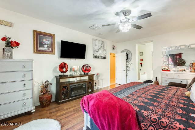 bedroom with ceiling fan and dark hardwood / wood-style floors