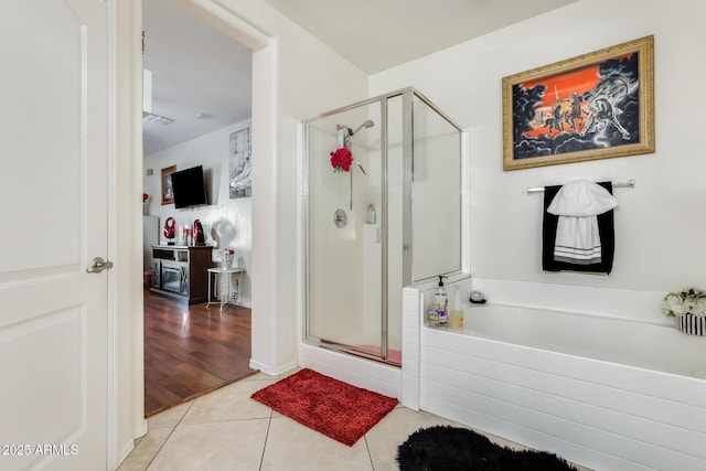 bathroom with tile patterned flooring and independent shower and bath