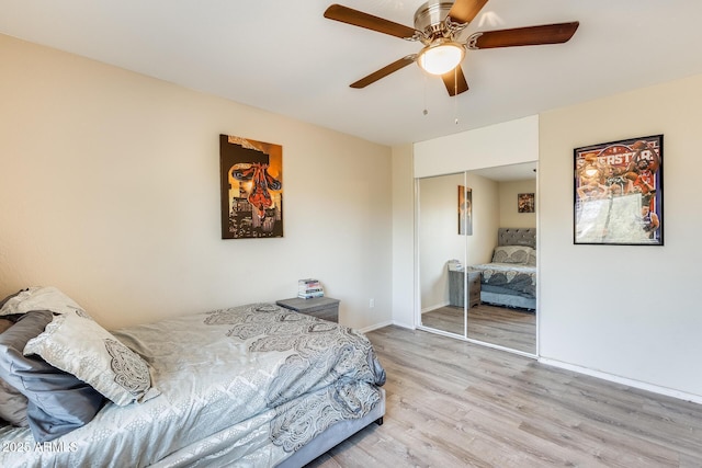 bedroom with a closet, ceiling fan, and light wood-type flooring