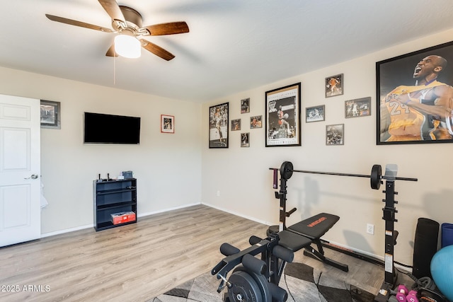 workout area with ceiling fan and light wood-type flooring