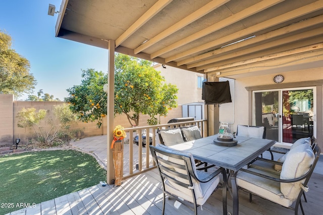 deck featuring a lawn and a storage shed