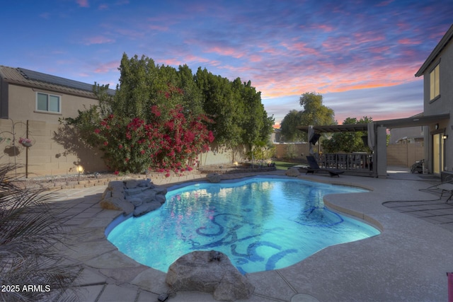 pool at dusk with a patio