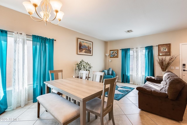 tiled dining area with a notable chandelier