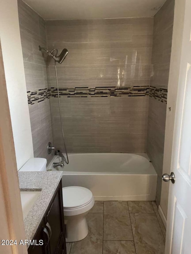 full bathroom featuring vanity, toilet, and tiled shower / bath combo