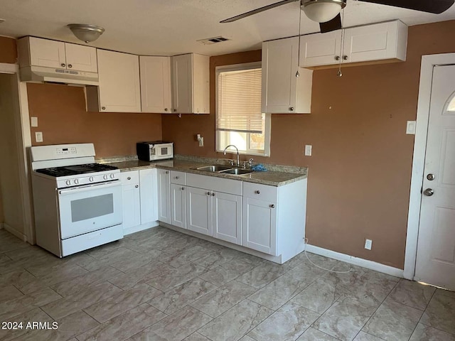 kitchen with white cabinets, ceiling fan, white appliances, and sink